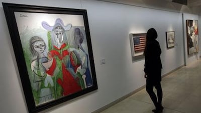 A 1961 Pablo Picasso painting titled Femme et Fillettes and Jasper Johns's Stars and Stripes painting, Flag, are among the works collected by the late author Michael Crichton that are going up for auction.