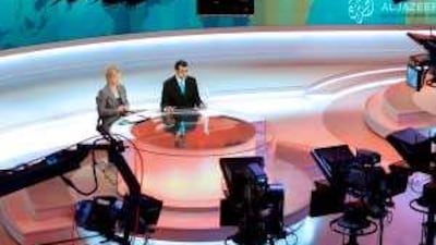 Newcasters in Al Jazeera's English language newsroom.