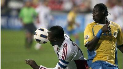 Ibrahim Diaky, left, tangles with an Al Gharafa player in Al Jazira's opener.