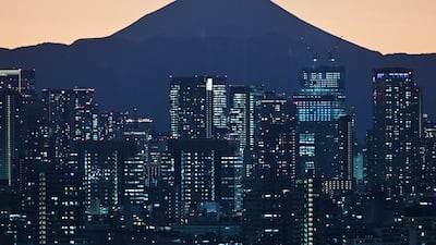 Mount Fuji, Japan’s highest mountain, is seen behind buildings in central Tokyo. AFP