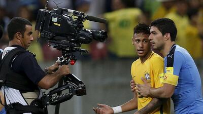 Luis Suarez (R) of Uruguay with Neymar of Brazil. REUTERS/Paulo Whitaker