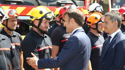 France's Prime Minister Emmanuel Macron meets firefighters in La Test-de-Buch, near Arcachon, south-western France, where two massive fires feeding on tinder-dry pine forests have forced tens of thousands of people to flee. AP