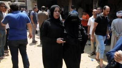 Families gather to retrieve the bodies of loved ones at the Zenhoum morgue following the deaths of hundreds of Egyptians in clashes between the Muslim Brotherhood and the interim government in the past week.