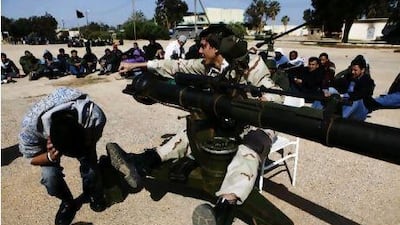 Libyan rebels teach volunteer recruits how to use an anti-aircraft gun at a base in Benghazi.