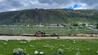 Flooding on the Yellowstone River undercuts the river bank, threatening a house and a garage in Gardiner, Montana. Parker Manning / AP