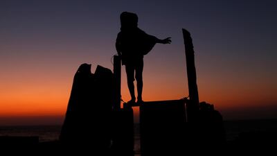 A Palestinian girl stands atop the entrance of her family house at Al-Shati refugee camp in Gaza City. Reuters