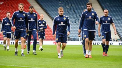 Scotland players shown warming up on Wednesday at a training session ahead of Thursday's EUro 2016 qualifying match against Poland. Brtlomiej Zborowski / EPA
