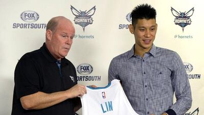 Charlotte Hornets basketball coach Steve Clifford, left, holds a jersey with newly acquired point guard Jeremy Lin during a news conference at Time Warner Cable Arena, Monday, July 13, 2015, in Charlotte, N.C. David T. Foster / The Charlotte Observer