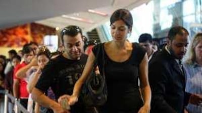 Passengers enter the metro station at the Mall of the Emirates.