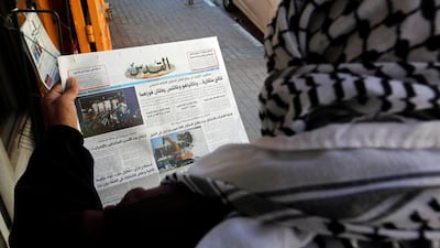 A Palestinian man reads a local newspaper with news of the Israeli election, in Hebron, in the Israeli-occupied West Bank. Reuters
