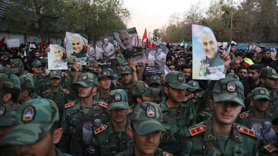 Army cadets attend a funeral ceremony for Qassem Suleimani, shown in posters, and his comrades at the Enqelab-e-Eslami (Islamic Revolution) square in Tehran. AP