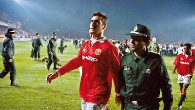 Manchester United player Eric Cantona is escorted from the pitch by a policeman after he was sent off at the end of the Champions League second round match with Galatasaray at the Ali Sami Yen stadium, Istanbul, on November 3, 1993. Getty Images
