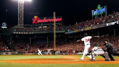 David Ortiz hit his first post-season grand slam Sunday night to tie it 5-5 in the eighth inning. Jared Wickerham / Getty Images / AFP