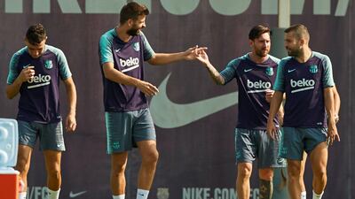 Barcelona's players Gerard Pique, centre, Lionel Messi, secon right and Jordi Alba, take part in training on Friday. EPA