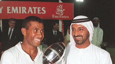 Fiji's captain Waisale Serevi (L) and Sheikh Ahmed bin Saeed Al Maktoum, head of Dubai Civil Aviation and Chairman of Emirates Airlines, hold the Dubai Rugby Sevens trophy 23 November after Fiji defeated world champions South Africa 33-12 in the final of the 3-day tournament. Jorge Ferrari / AFP