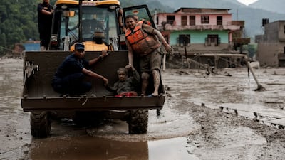 A survivor is transported to safety via heavy machinery. Reuters