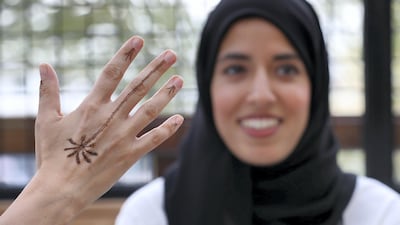 Henna artist Azra Khamissa and one of her minimalist patterns. Chris Whiteoak / The National