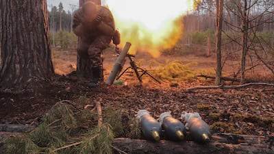 A Ukrainian soldier shoots at the Russian positions not far from the capital Kyiv. EPA