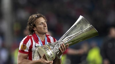 Forlan holds the Europa League trophy after Atletico’s victory against Fulham in the final in Hamburg on May 12, 2010. Ina Fassbender / Reuters