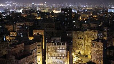 The ancient towers and buildings of Old Sana'a give way to the lights of modern buildings in the Yemeni capital.