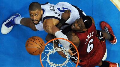 Miami Heat's LeBron James, right, and Dallas Mavericks' Tyson Chandler go after a rebound during the second half of Game 4.