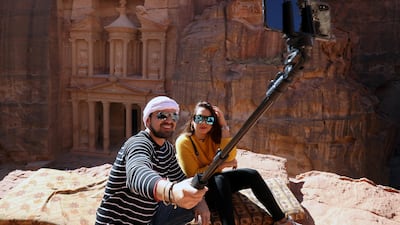 Tourists take selfie pictures in front of the treasury site in the ancient city of Petra, south of Amman, Jordan. Reuters