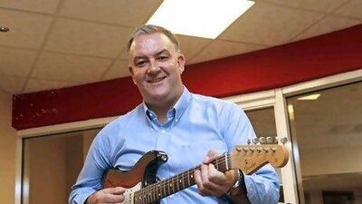 Dave Robinson strums the PR message. Jeffrey E Biteng / The National