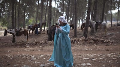An enthusiast wearing a costume looks at her mobile phone during a re-enactment of a decisive Crusaders battle in occupied Palestine’s Galilee region July 5, 2014. About 50 people participated in the re-enactment of the Battle of the Horns of Hattin, where Muslim forces led by the legendary Salah al-Din defeated Christian fighters in the late 12th century. Reuters