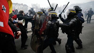French riot police clash with protesters in Nantes, on a day of nationwide strikes and protests over proposed pension reforms. AFP