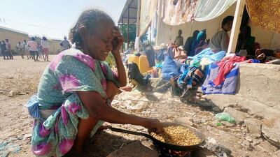 An Ethiopian who fled the ongoing fighting in Tigray region, prepares a meal in Hamdait village on the Sudan-Ethiopia border in eastern Kassala state, Sudan Reuters