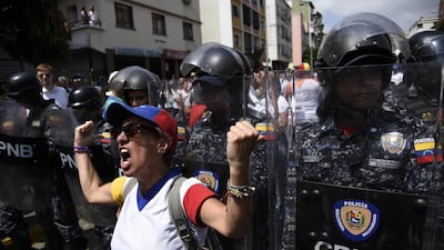 A protester shouts at Bolivarian National Police officers during an anti-government rally in Caracas, Venezuela. Bloomberg
