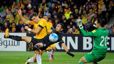 Tomi Juric of Australia, left, and Adisorn Promrak of Thailand, centre, in action. Jason Reed / Reuters