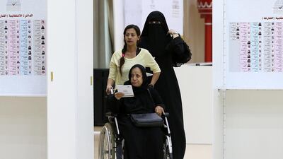 Fathiya Obaid casts her vote in the Sharjah Consultative Council elections at the Sharjah Chess Club on Thursday. Pawan Singh / The National