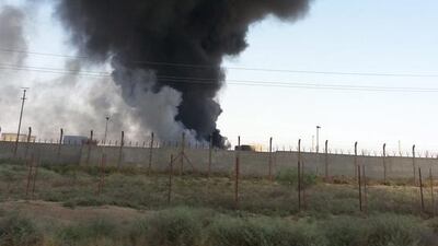 Smoke rises from the the Baiji oil refinery in northern Iraq on June 19 2014. Workers were evacuated from Iraq's key Baiji refinery, local sources said, as it remained unclear who was actually in control of the plant which accounts for almost a third of the country's refining capacity. EPA / STR