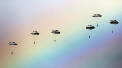 Russian paratroopers jump as a rainbow appears in the sky during the joint Russian, Belarusian and Serbian military exercise “The Slavic Brotherhood” at the military ground Kovin, near Belgrade. Stringer / AFP
