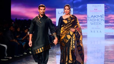 Bollywood actors Karan Singh Grover, left, and Bipasha Basu present creations by Sanjuktta Dutta during Lakme Fashion Week in Mumbai on February 14, 2020. AFP