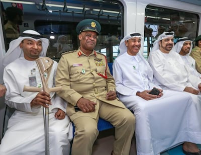 From left, Emirati paralympian Naseeb Sebait; Maj Gen Anas Al Matrooshi of Dubai Police; Hussain Lootah of Dubai Municipality; Khalifa bin Darray of Dubai Ambulance Service; and Obaid Al Shamsi, also of the municipality, take the metro. Victor Besa / The National
