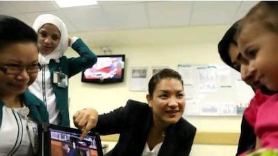 Bunna Eng-Tusitala, the burns unit manager at Mafraq Hospital, talks to children about dangers in the ktichen.