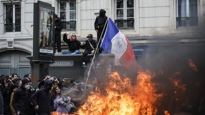 Protesters set rubbish on fire in the streets of Paris. EPA