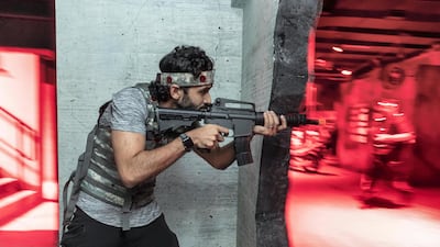 XStrike features live combat simulation with participants taking part in a gun battle using laser-based toy guns. Photo: Antonie Robertson / The National