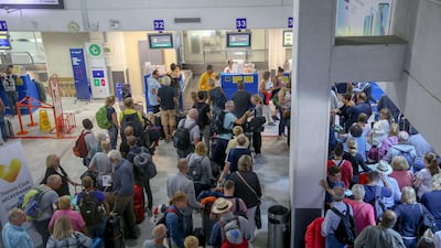 People line up in front of a counter of Thomas Cook at the Heraklion airport on the island of Crete, Greece. REUTERS