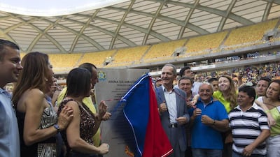 Brazil's Sports Minister Aldo Rebelo (centre, gray suit) uncovers a plaque during the inauguration of the Arena Amazonia Vivaldo Lima on Sunday. Rebelo sounded confident with one of the most problematic stadiums, Curitiba, now more than 97 per cent complete. Bruno Kelly / Reuters / March 9, 2014