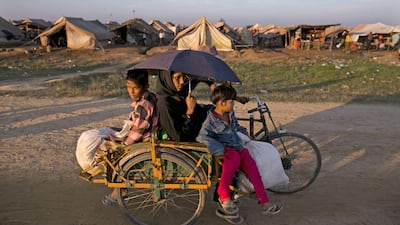 A rickshaw passes in front of a crowded IDP camp November 23, 2012 on the outskirts of Sittwe, Myanmar. Paula Bronstein / Getty Images