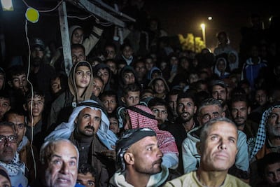 Palestinians watch in the dark, using what little electricity Gaza has. AFP