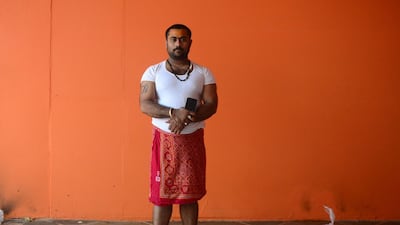 Indian priest Pawan Pandey, 30, poses with his smartphone at a Hanuman temple near the Sangam area in Allahabad. AFP
