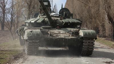 A Ukrainian service member drives a captured Russian T-72 tank in late March. More have been sent to help Ukraine. Reuters