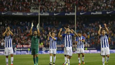 Alaves players celebrate with their supporters at the end of their 1-1 draw to Atletico Madrid. (Francisco Seco/AP)