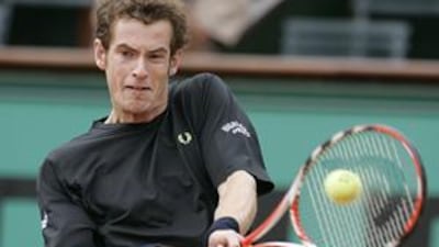 Britain's Andy Murray returns a ball to Italy's Potito Starace during their second round match on Wednesday. Murray overcame a slump in form in the middle of the match to go through in four sets.