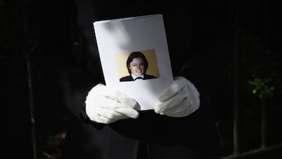 A female police officer holds an order of service during a memorial service to Ms Fletcher in April 2014
