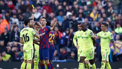 Referee Guillermo Cuadra Fernandez shows Sergio Busquets a yellow card. Getty Images